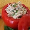 A stuffed tomato with meat and rice in it.