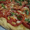 A close up of some food on top of a pizza