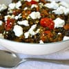 A bowl of food with feta cheese on top.