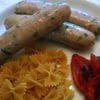 A plate of food with sausage and pasta.