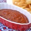 A bowl of chili and french fries on the side.