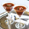Two glasses of chocolate pudding on a silver tray.