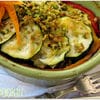 A bowl of food with some vegetables on it