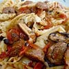 A plate of pasta with meat and vegetables.