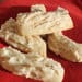 A red plate with some white fudge on it