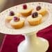 A white plate with some cupcakes on it