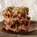 A stack of three pieces of cranberry oatmeal bars.