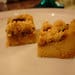 A white plate topped with two pieces of cake.