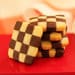 A stack of cookies with checkerboard design on top.